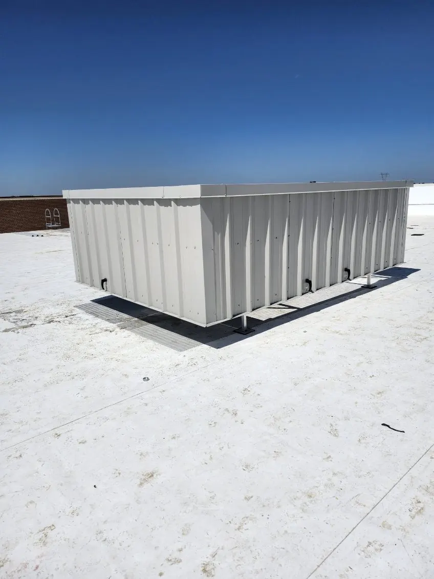 Ash gray solid-panel RTU screen enclosure on a white commercial rooftop
