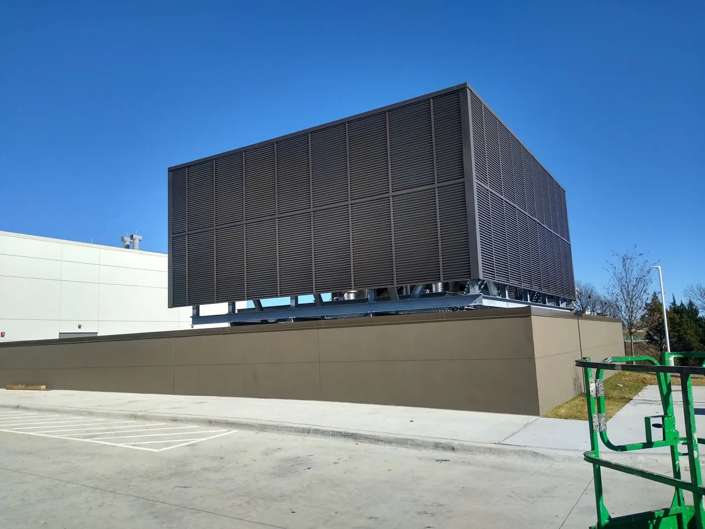 Dark bronze louvered mechanical equipment screen on a steel frame